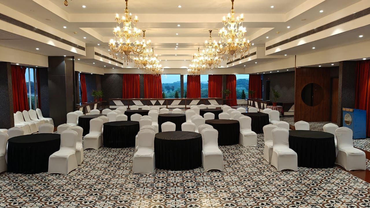 Chandelier banquet hall arranged in cluster seating for a corporate dinner