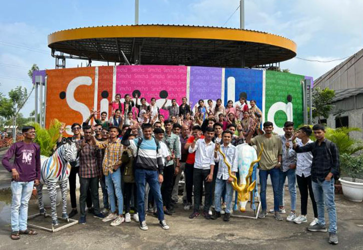 Large corporate group at the colourful Simcha Island entrance sign