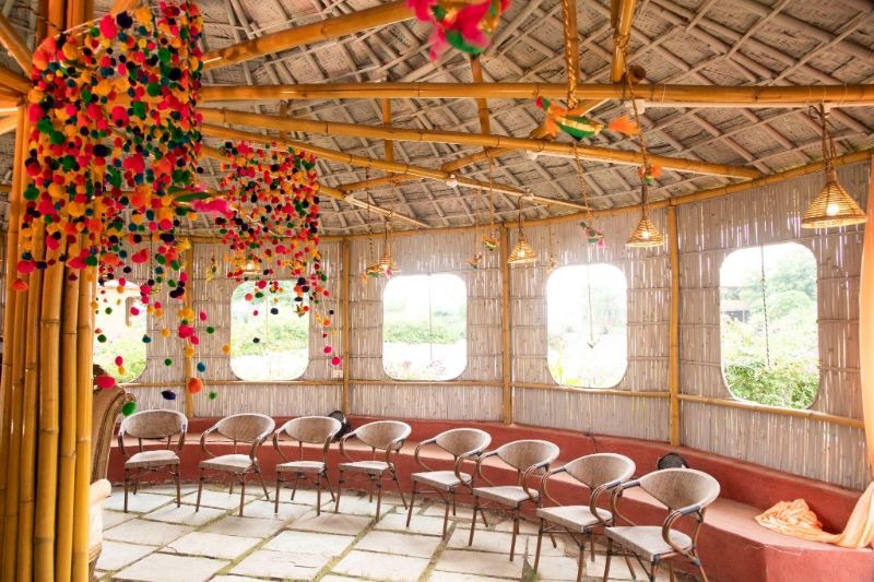 Bamboo pavilion decorated with colourful pom-poms for an offsite gathering