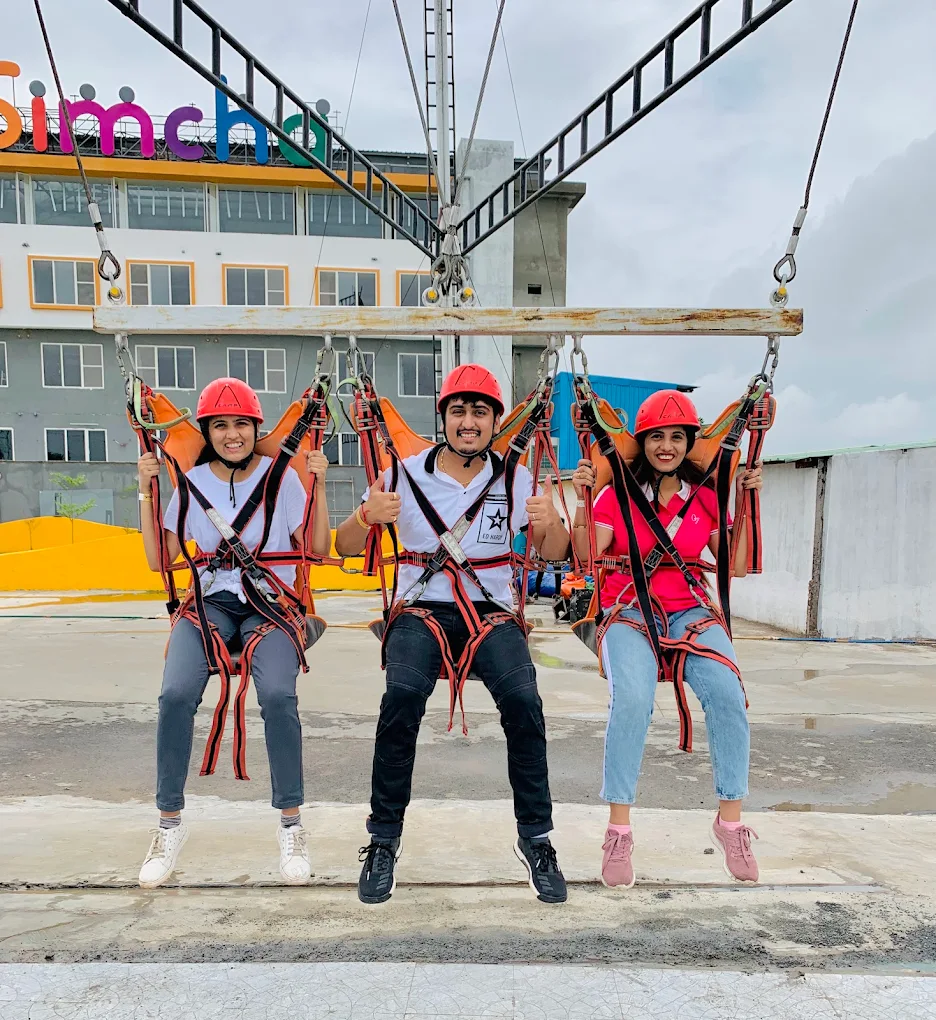 Colleagues enjoying the giant swing adventure activity at Simcha Island